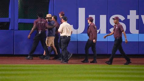 mets fan falls onto field|More.